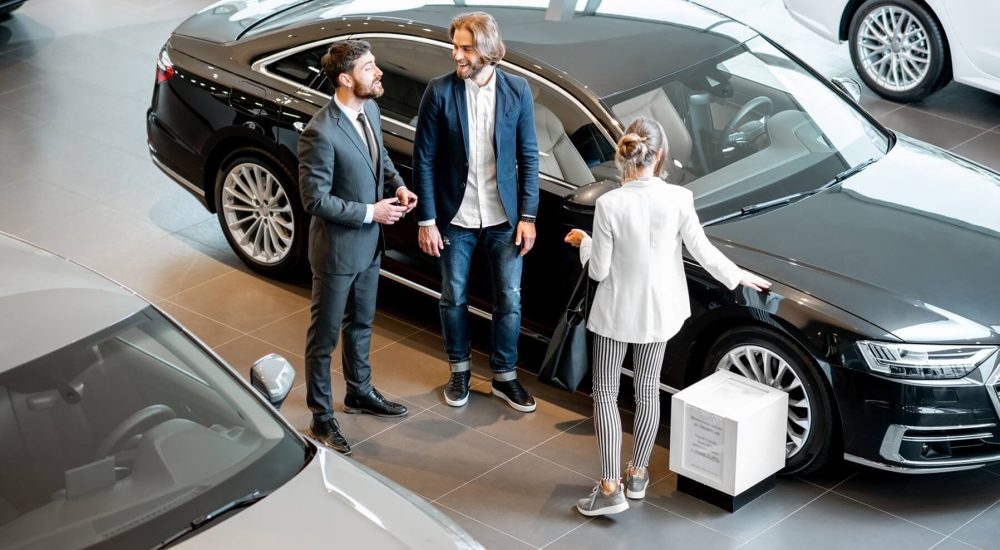 business-couple-with-salesperson-in-the-car-showro-2025-03-16-03-18-56-utc.jpg