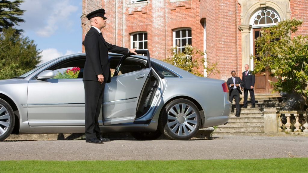 chauffeur-opens-car-door-for-businessmen-2026-03-26-04-47-25-utc